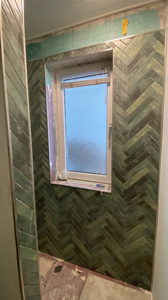 Fliesenwand im Fischgrätmuster am Fenster